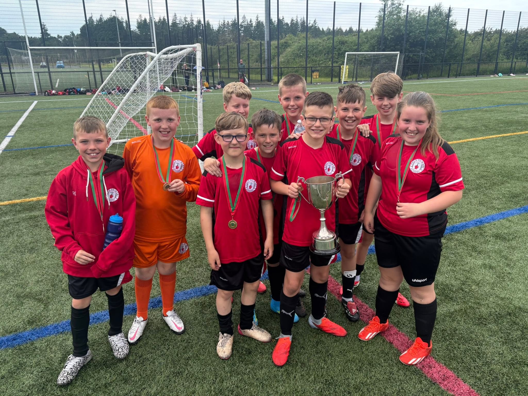 A primary school team with their cup