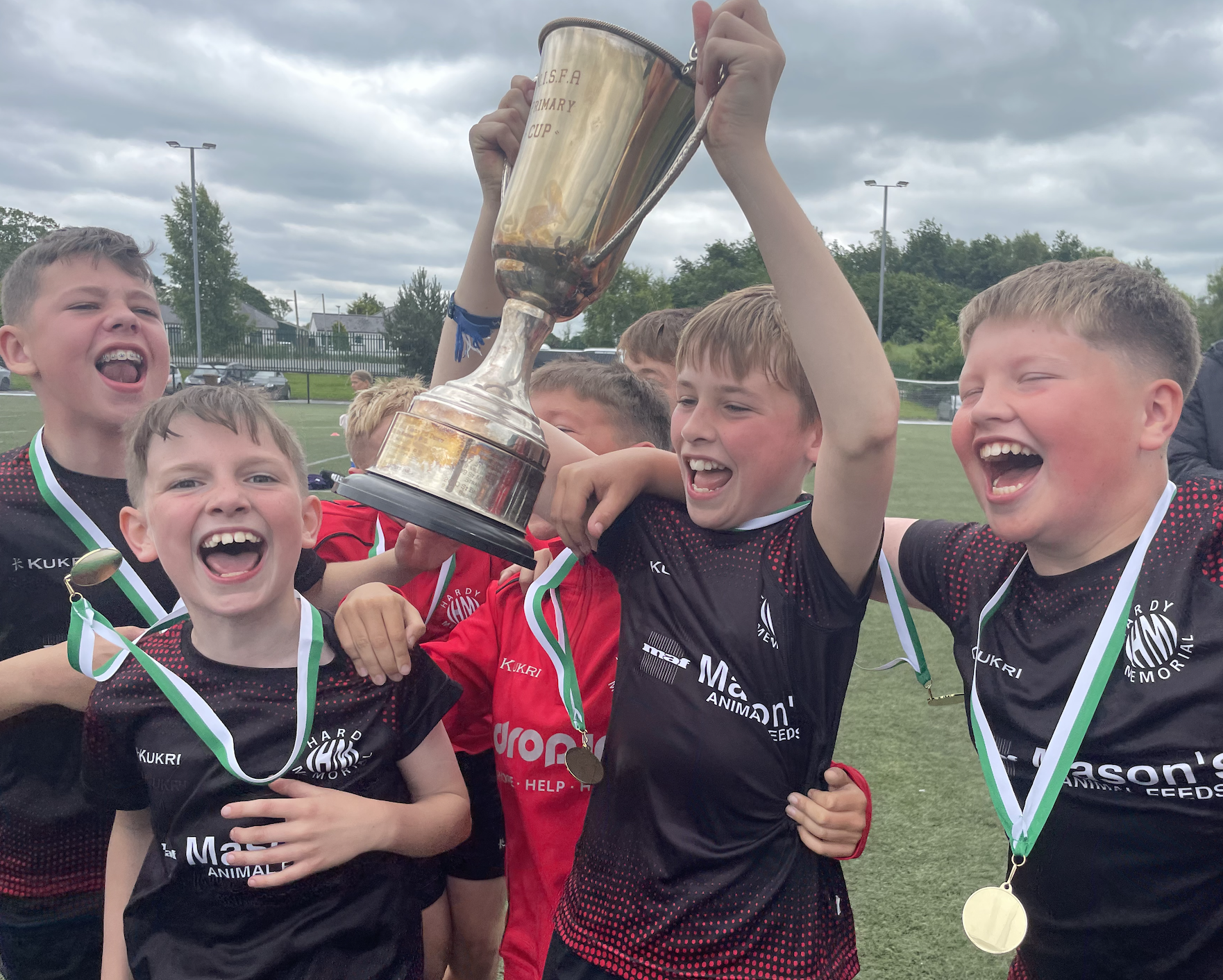 Primary pupils celebrating with the NISFA Primary Cup